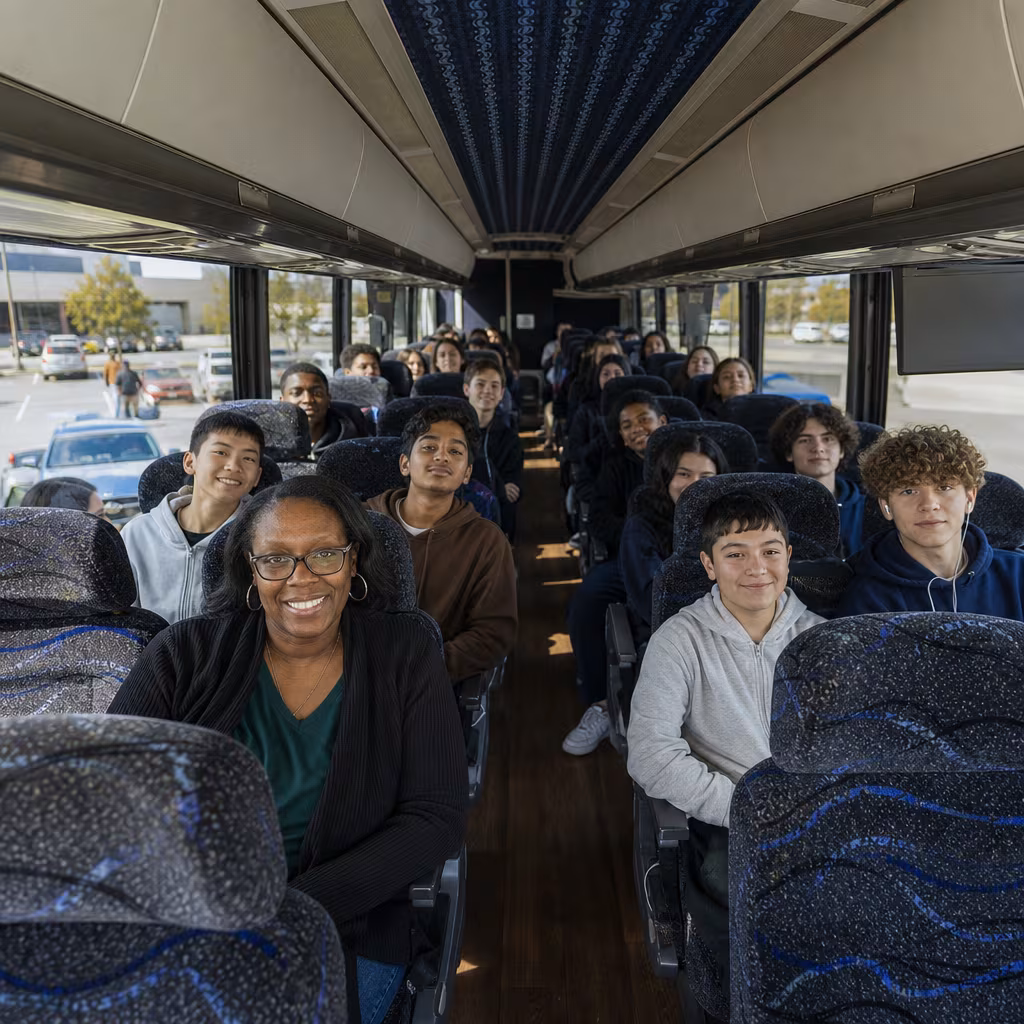 Group boarding a white charter bus for School Transportation transportation in San Francisco